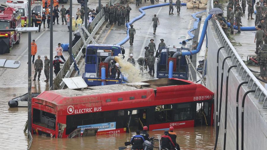 Tim penyelamat mencari korban di sepanjang jalan yang terendam banjir menuju terowongan bawah tanah di Cheongju, Korea Selatan, Minggu, 16 Juli 2023. Hujan deras berhari-hari memicu banjir bandang dan tanah longsor serta menghancurkan rumah, menyebabkan puluhan orang tewas dan memaksa ribuan orang mengungsi. mengungsi, kata para pejabat, Minggu. (Kim Ju-hyung/Yonhap via AP)