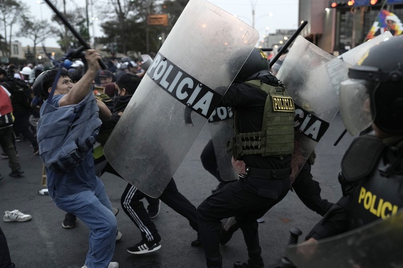 Anti-government protesters clash with police in downtown Lima, Peru, Wednesday, July 19, 2023. The protesters are demanding that Peruvian President Dina Boluarte call for immediate presidential elections as well as justice for those who were killed during protests after the ouster of her predecessor Pedro Castillo. (AP Photo/Rodrigo Abd)
