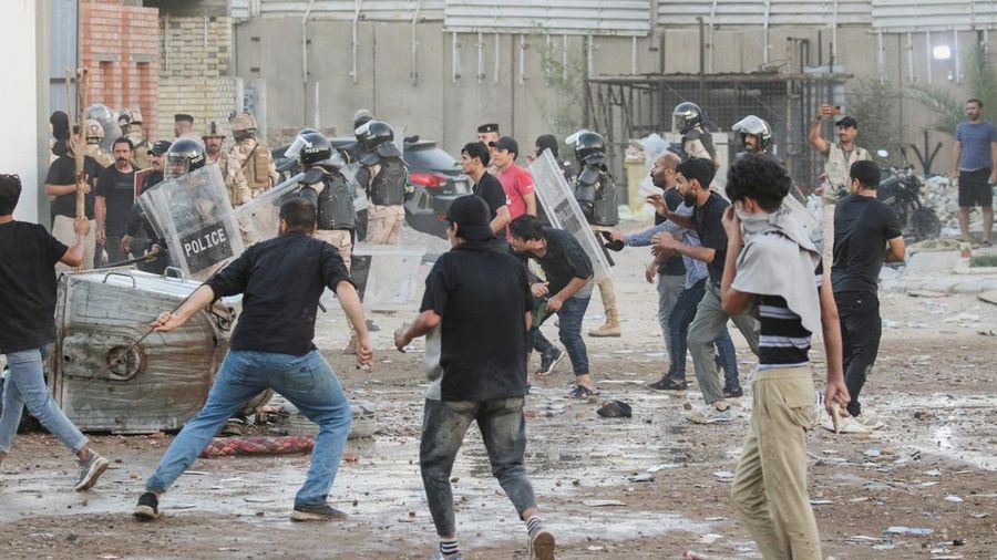 Protesters clash with members of the police as they gather near the Swedish embassy in Baghdad hours after the embassy was stormed and set on fire ahead of an expected Koran burning in Stockholm, in Baghdad, Iraq, July 20, 2023. REUTERS/Ahmed Saad