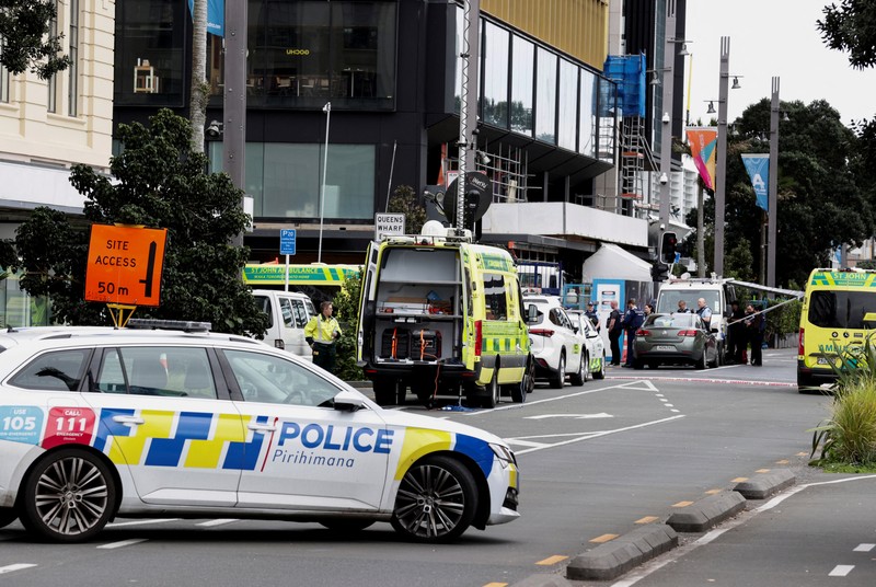 Police cars are seen near a construction site following a shooting in the central business district, in Auckland, New Zealand July 20, 2023. REUTERS/David Rowland