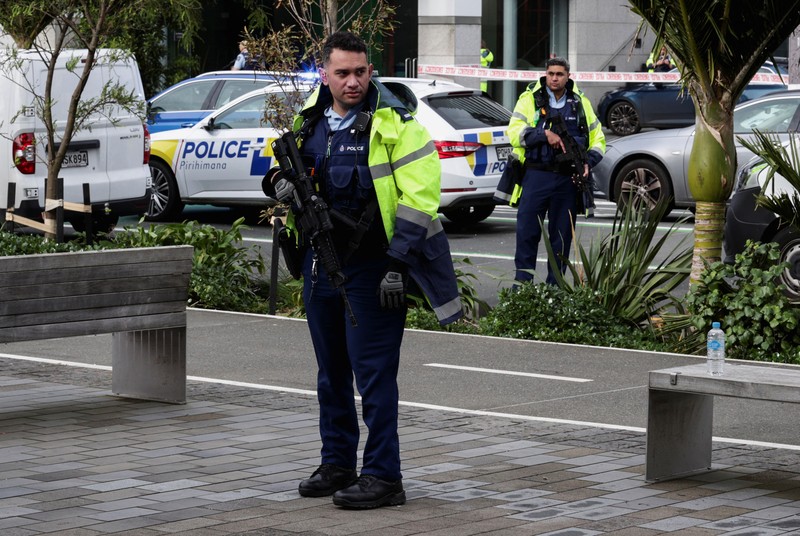 NEWZEALAND-SHOOTING/ Police cars are seen near a construction site following a shooting in the central business district, in Auckland, New Zealand July 20, 2023. REUTERS/David Rowland