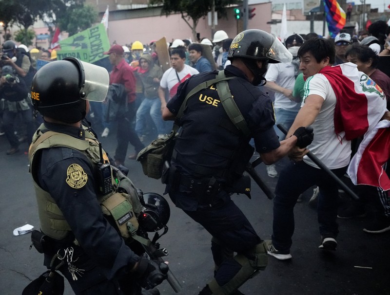 Anti-government protesters clash with police in downtown Lima, Peru, Wednesday, July 19, 2023. The protesters are demanding that Peruvian President Dina Boluarte call for immediate presidential elections as well as justice for those who were killed during protests after the ouster of her predecessor Pedro Castillo. (AP Photo/Rodrigo Abd)