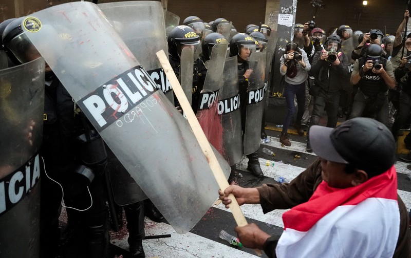 Anti-government protesters clash with police in downtown Lima, Peru, Wednesday, July 19, 2023. The protesters are demanding that Peruvian President Dina Boluarte call for immediate presidential elections as well as justice for those who were killed during protests after the ouster of her predecessor Pedro Castillo. (AP Photo/Rodrigo Abd)