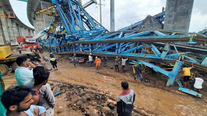 Petugas penyelamat mencari korban selamat dari sebuah crane runtuh saat pembangunan jembatan di distrik Thane di negara bagian barat Maharashtra, India, 1 Agustus 2023. (REUTERS/Stringer)