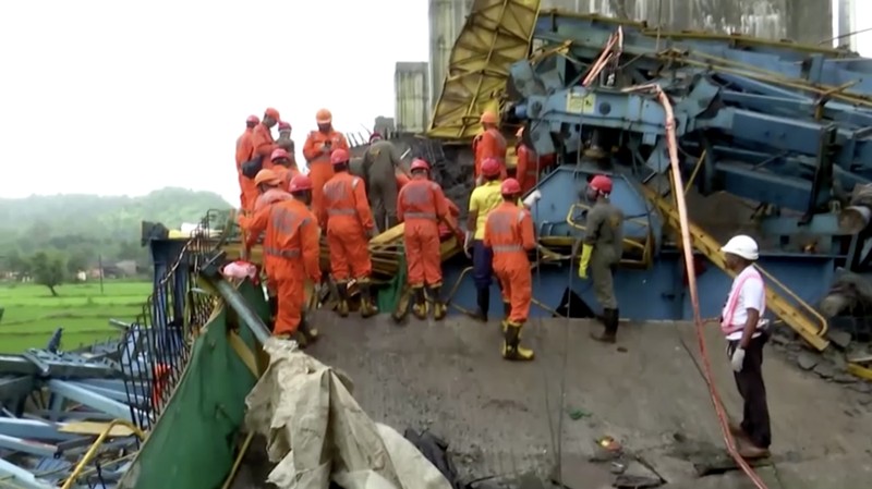 Petugas penyelamat mencari korban selamat dari sebuah crane runtuh saat pembangunan jembatan di distrik Thane di negara bagian barat Maharashtra, India, 1 Agustus 2023. (REUTERS/Stringer)