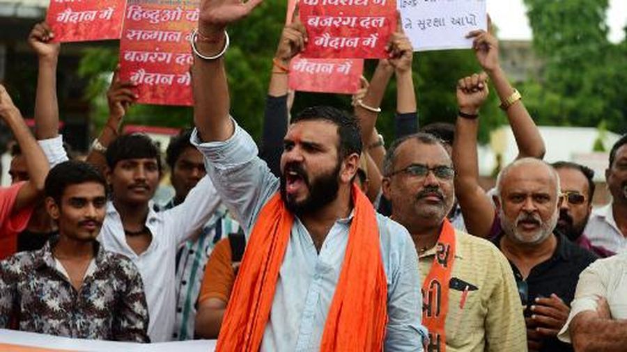 Activists and supporters of Vishwa Hindu Parishad (VHP) and Bajrang Dal organisations shout slogans during a demonstration against the communal clashes in India's Haryana state, during a protest in Ahmedabad on August 2, 2023. Riot police were patrolling urban neighbourhoods near India's capital on August 3, following a second night of sectarian riots that have killed six people so far. (Photo by SAM PANTHAKY / AFP)