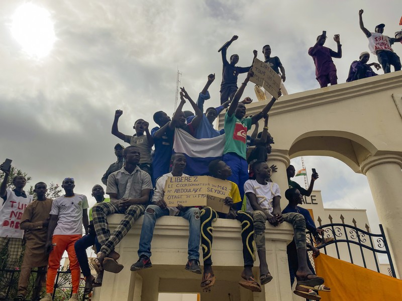 Pendukung junta yang berkuasa Niger memegang bendera Rusia pada awal protes yang menyerukan untuk memperjuangkan kebebasan negara dan menolak campur tangan asing di Niamey, Niger, Kamis, 3 Agustus 2023. Pendukung junta yang berkuasa Niger memegang bendera Rusia pada awal protes yang menyerukan untuk memperjuangkan kebebasan negara dan menolak campur tangan asing di Niamey, Niger, Kamis, 3 Agustus 2023. Pawai jatuh pada kemerdekaan negara Afrika Barat hari dari mantan penguasa kolonialnya, Prancis, dan ketika sentimen anti-Prancis melonjak, lebih dari satu minggu setelah tentara yang memberontak menggulingkan presiden negara yang terpilih secara demokratis. (AP Photo/Sam Mednick)