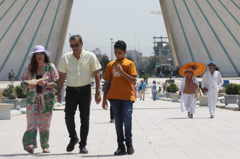 Turis berjalan di jalan selama gelombang panas di Teheran, Iran 2 Agustus 2023. Turis berjalan di jalan selama gelombang panas di Teheran, Iran 2 Agustus 2023. (Majid Asgaripour/WANA (West Asia News Agency) via REUTERS)