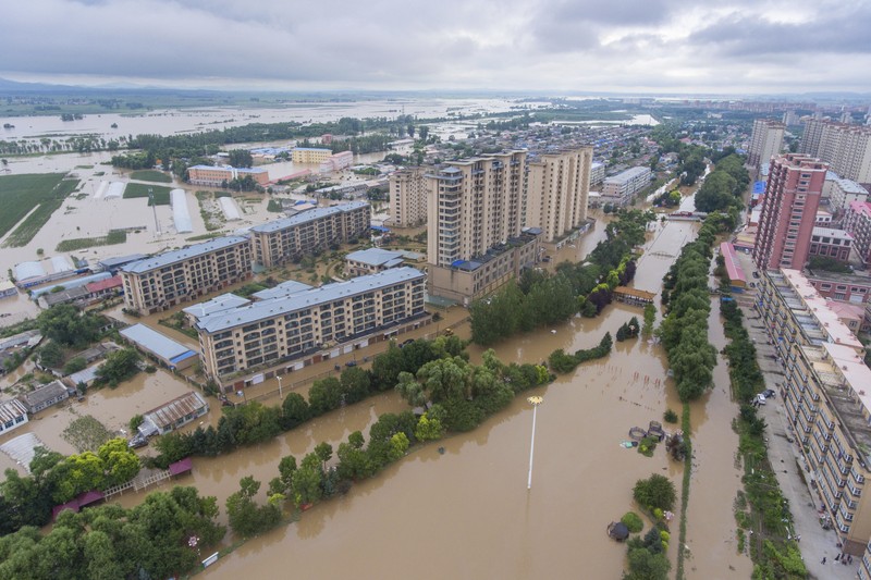 In this aerial photo released by Xinhua News Agency, flood waters course through fields and roads in Kaiyuan Town of Shulan in northeastern China's Jilin Province on Friday, Aug. 4, 2023. Northeastern China continued to be pelted by rain on Saturday, as authorities reported more deaths and missing people and evacuated thousands in the wake of Typhoon Doksuri. (Yan Linyun/Xinhua via AP)