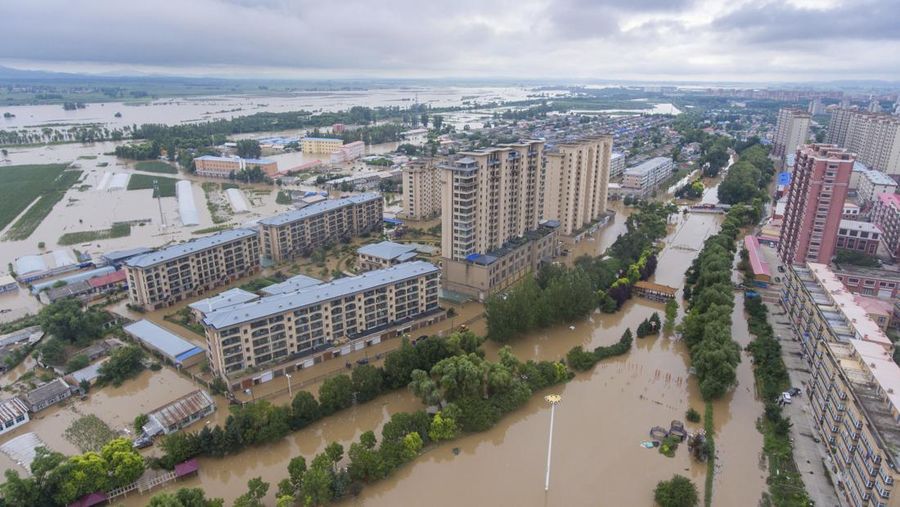 In this aerial photo released by Xinhua News Agency, flood waters course through fields and roads in Kaiyuan Town of Shulan in northeastern China's Jilin Province on Friday, Aug. 4, 2023. Northeastern China continued to be pelted by rain on Saturday, as authorities reported more deaths and missing people and evacuated thousands in the wake of Typhoon Doksuri. (Yan Linyun/Xinhua via AP)