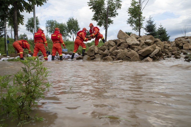 In this aerial photo released by Xinhua News Agency, flood waters course through fields and roads in Kaiyuan Town of Shulan in northeastern China's Jilin Province on Friday, Aug. 4, 2023. Northeastern China continued to be pelted by rain on Saturday, as authorities reported more deaths and missing people and evacuated thousands in the wake of Typhoon Doksuri. (Yan Linyun/Xinhua via AP)