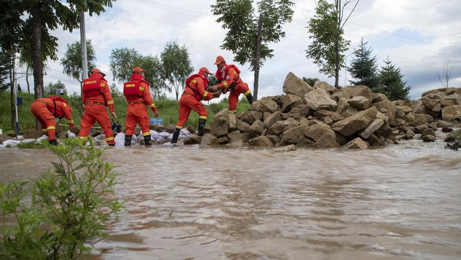In this aerial photo released by Xinhua News Agency, flood waters course through fields and roads in Kaiyuan Town of Shulan in northeastern China's Jilin Province on Friday, Aug. 4, 2023. Northeastern China continued to be pelted by rain on Saturday, as authorities reported more deaths and missing people and evacuated thousands in the wake of Typhoon Doksuri. (Yan Linyun/Xinhua via AP)