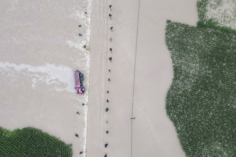 In this aerial photo released by Xinhua News Agency, flood waters course through fields and roads in Kaiyuan Town of Shulan in northeastern China's Jilin Province on Friday, Aug. 4, 2023. Northeastern China continued to be pelted by rain on Saturday, as authorities reported more deaths and missing people and evacuated thousands in the wake of Typhoon Doksuri. (Yan Linyun/Xinhua via AP)
