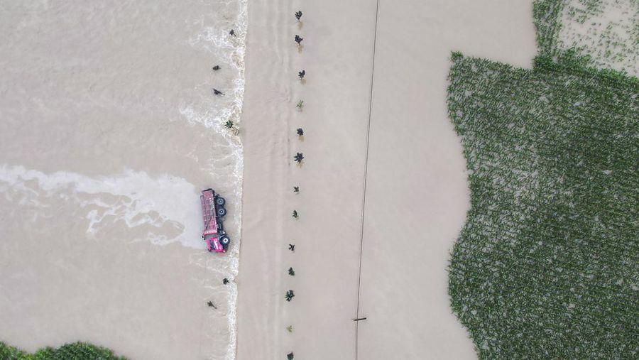 In this aerial photo released by Xinhua News Agency, flood waters course through fields and roads in Kaiyuan Town of Shulan in northeastern China's Jilin Province on Friday, Aug. 4, 2023. Northeastern China continued to be pelted by rain on Saturday, as authorities reported more deaths and missing people and evacuated thousands in the wake of Typhoon Doksuri. (Yan Linyun/Xinhua via AP)
