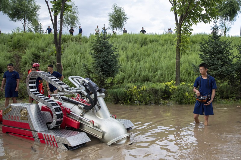 In this aerial photo released by Xinhua News Agency, flood waters course through fields and roads in Kaiyuan Town of Shulan in northeastern China's Jilin Province on Friday, Aug. 4, 2023. Northeastern China continued to be pelted by rain on Saturday, as authorities reported more deaths and missing people and evacuated thousands in the wake of Typhoon Doksuri. (Yan Linyun/Xinhua via AP)