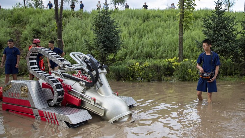 In this aerial photo released by Xinhua News Agency, flood waters course through fields and roads in Kaiyuan Town of Shulan in northeastern China's Jilin Province on Friday, Aug. 4, 2023. Northeastern China continued to be pelted by rain on Saturday, as authorities reported more deaths and missing people and evacuated thousands in the wake of Typhoon Doksuri. (Yan Linyun/Xinhua via AP)