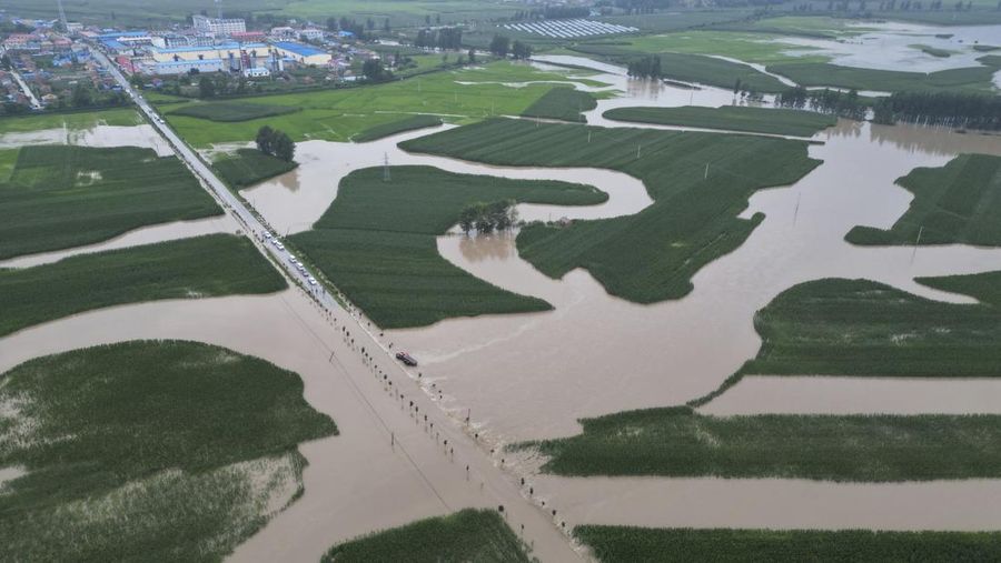 In this aerial photo released by Xinhua News Agency, flood waters course through fields and roads in Kaiyuan Town of Shulan in northeastern China's Jilin Province on Friday, Aug. 4, 2023. Northeastern China continued to be pelted by rain on Saturday, as authorities reported more deaths and missing people and evacuated thousands in the wake of Typhoon Doksuri. (Yan Linyun/Xinhua via AP)