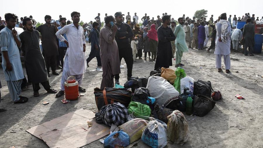 Petugas polisi berkumpul di lokasi kereta tergelincir di kota Sarhari di distrik Sanghar, Pakistan 6 Agustus 2023. (REUTERS/Yasir Rajput)
