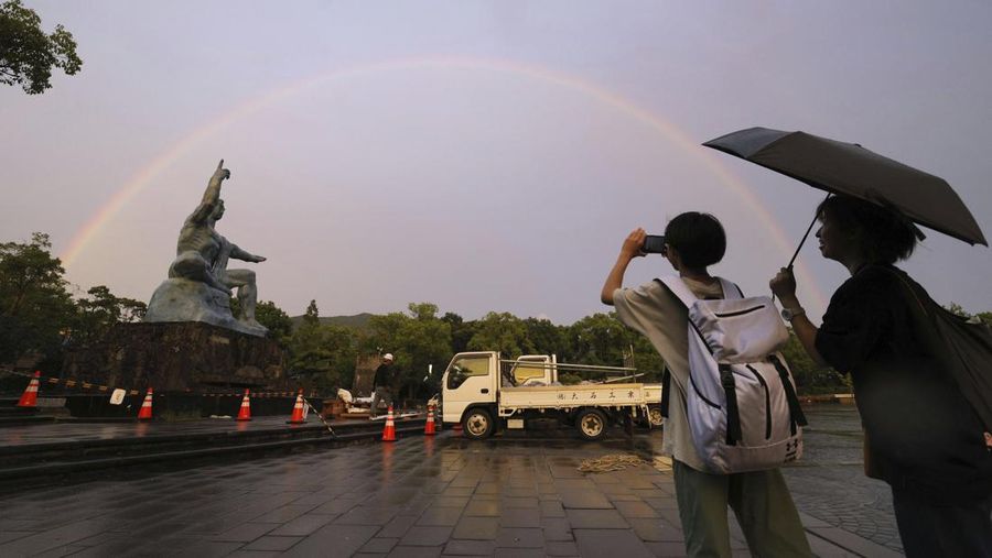 A rainbow appears in the sky over Peace Park in Nagasaki, Japan, Tuesday, Aug. 8, 2023, a day before the 78th anniversary of the U.S. atomic bombing of the southwestern Japan city. Early Tuesday morning, the storm was centered 350 kilometers (217 miles) south of Kagoshima, a city on the southwestern tip of Japan’s main southern island of Kyushu and south of Nagasaki. Khanun produced winds of 108 kph (67 mph) with gusts to 144 kph (89 mph) and was slowly moving north, the Japan Meteorological Agency reported. (Kyodo News via AP)