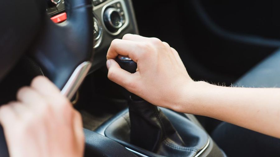 Woman in vehicle interior on driver seat