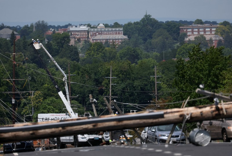 USA-WEATHER/WASHINGTON A downed power line that fell on an SUV can be seen the day after a powerful storm swept the region along Baltimore Blvd in Westminster, Maryland, U.S., August 8, 2023. REUTERS/Leah Millis