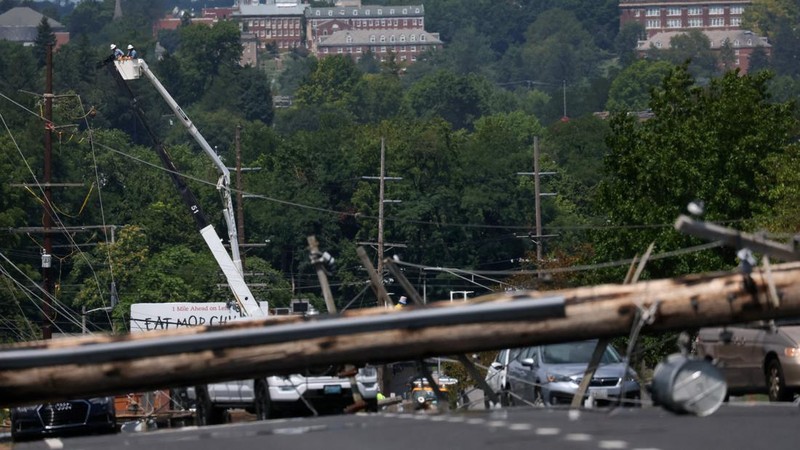 A downed power line that fell on an SUV can be seen the day after a powerful storm swept the region along Baltimore Blvd in Westminster, Maryland, U.S., August 8, 2023. REUTERS/Leah Millis