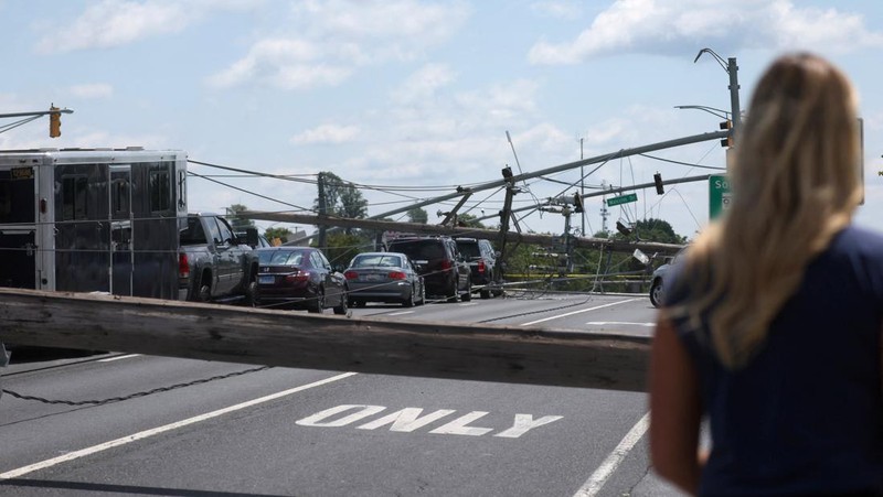 A downed power line that fell on an SUV can be seen the day after a powerful storm swept the region along Baltimore Blvd in Westminster, Maryland, U.S., August 8, 2023. REUTERS/Leah Millis