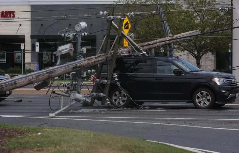 USA-WEATHER/WASHINGTON A downed power line that fell on an SUV can be seen the day after a powerful storm swept the region along Baltimore Blvd in Westminster, Maryland, U.S., August 8, 2023. REUTERS/Leah Millis