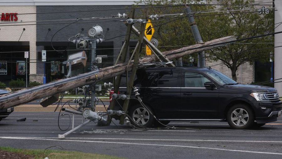 A downed power line that fell on an SUV can be seen the day after a powerful storm swept the region along Baltimore Blvd in Westminster, Maryland, U.S., August 8, 2023. REUTERS/Leah Millis