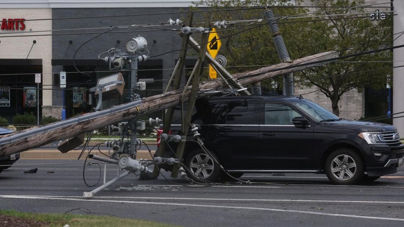 A downed power line that fell on an SUV can be seen the day after a powerful storm swept the region along Baltimore Blvd in Westminster, Maryland, U.S., August 8, 2023. REUTERS/Leah Millis