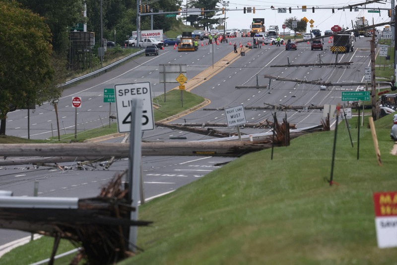 USA-WEATHER/WASHINGTON A downed power line that fell on an SUV can be seen the day after a powerful storm swept the region along Baltimore Blvd in Westminster, Maryland, U.S., August 8, 2023. REUTERS/Leah Millis