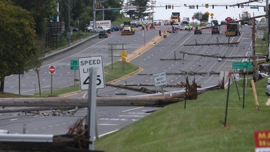 A downed power line that fell on an SUV can be seen the day after a powerful storm swept the region along Baltimore Blvd in Westminster, Maryland, U.S., August 8, 2023. REUTERS/Leah Millis