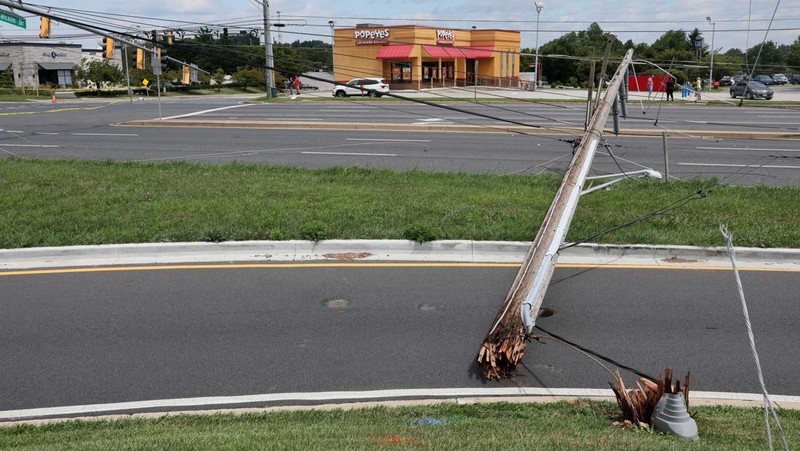 A downed power line that fell on an SUV can be seen the day after a powerful storm swept the region along Baltimore Blvd in Westminster, Maryland, U.S., August 8, 2023. REUTERS/Leah Millis