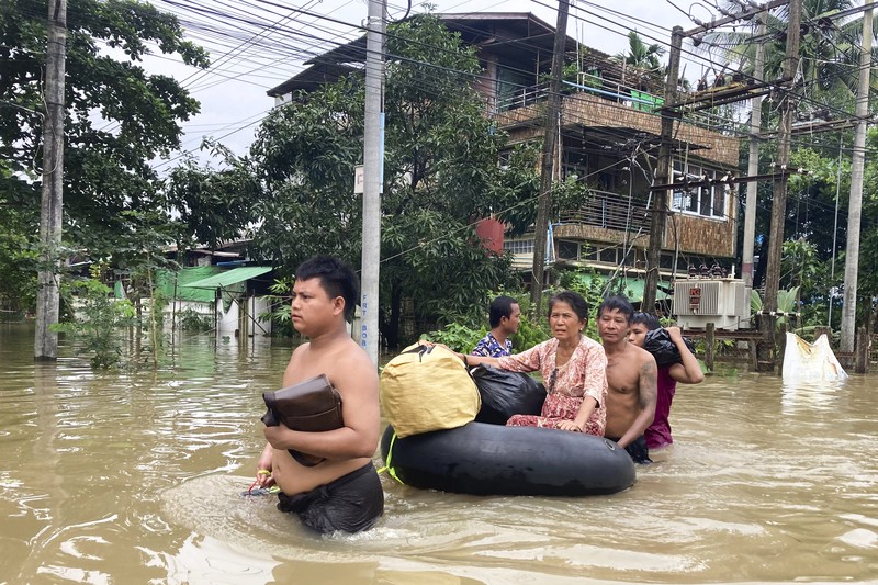Penduduk setempat menaiki rakit yang terbuat dari ban dalam di sepanjang jalan yang banjir di Bago, Myanmar, sekitar 80 kilometer (50 mil) timur laut Yangon, Jumat, 11 Agustus 2023. Penduduk setempat menaiki rakit yang terbuat dari ban dalam di sepanjang jalan yang banjir di Bago, Myanmar, sekitar 80 kilometer (50 mil) timur laut Yangon, Jumat, 11 Agustus 2023. (AP Photo)