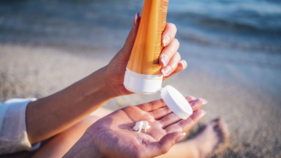 Mirror reflection of woman with skincare cream, spa lotion or dermatology ointment for melasma or acne treatment. Bathroom facial routine, healthcare and face of girl apply cosmetics beauty product