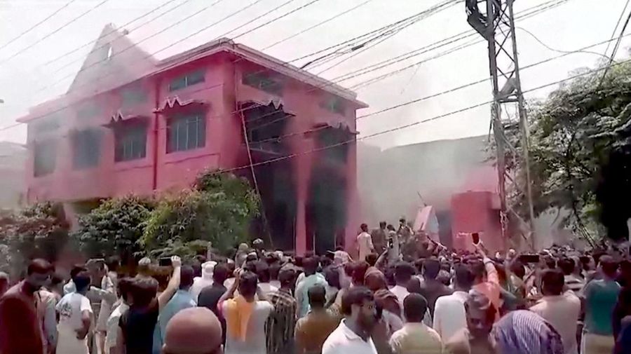 Seorang pengunjuk rasa berdiri di atap sebuah gereja merusak struktur bangunan di Jaranwala, Pakistan 16 Agustus 2023. (REUTERS TV via REUTERS)