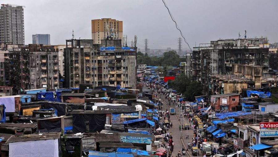 People and vehicles move past shanties in Dharavi, one of Asia's largest slums, in Mumbai, India, August 1, 2023. REUTERS/Niharika Kulkarni