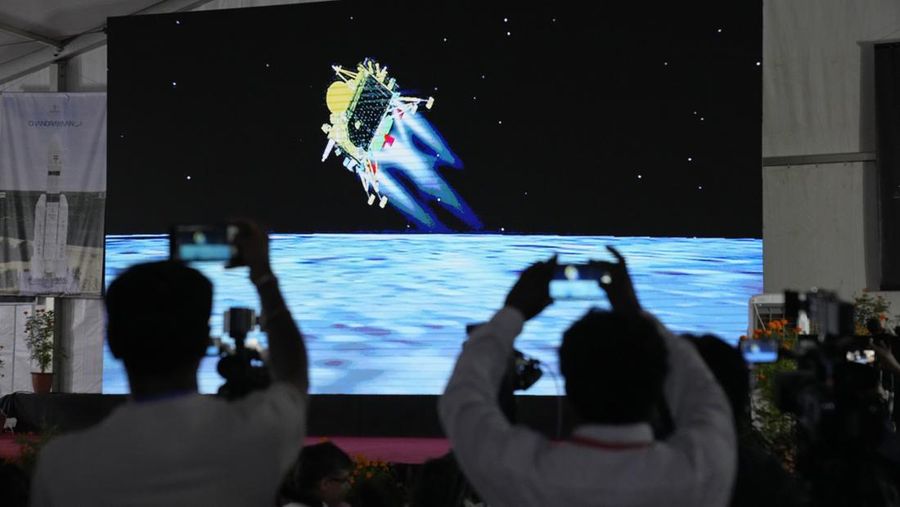 Journalists film the live telecast of spacecraft Chandrayaan-3 landing on the moon at ISRO's Telemetry, Tracking and Command Network facility in Bengaluru, India, Wednesday, Aug. 23, 2023. India has landed a spacecraft near the moon’s south pole, an uncharted territory that scientists believe could hold vital reserves of frozen water and precious elements, as the country cements its growing prowess in space and technology. (AP Photo/Aijaz Rahi)