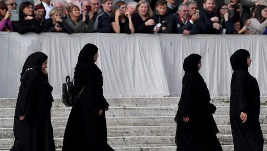 Women wearing traditional Emirati Abaya, from a delegation of the United Arab Emirates, attend the Pope's the weekly general audience on November 27, 2019 at St. Peter's Square in the Vatican. (Photo by Tiziana FABI / AFP)