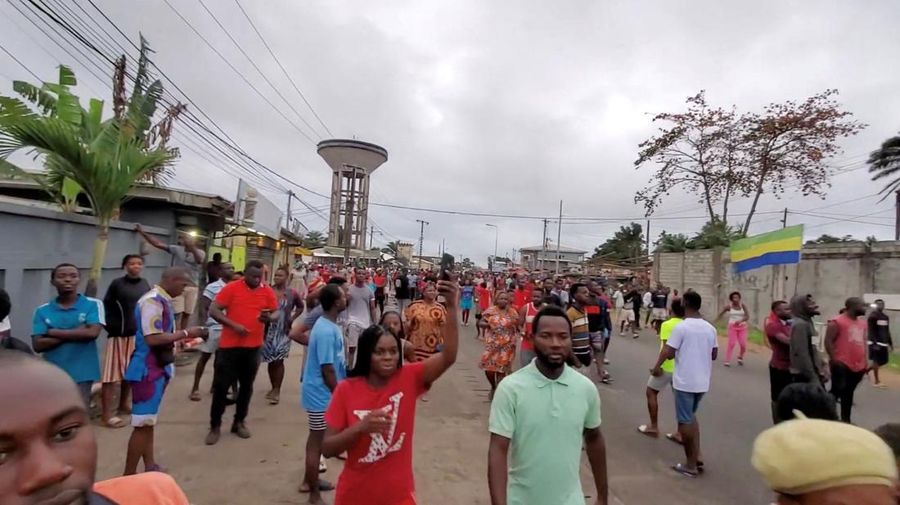 People gather as they celebrate after military officers announced they had taken power, after the state election body announced President Ali Bongo had won a third term, in Port Gentil, Gabon August 30, 2023 in this still image obtained from social media video. Gaetan M-Antchouwet/via REUTERS  THIS IMAGE HAS BEEN SUPPLIED BY A THIRD PARTY. MANDATORY CREDIT. NO RESALES. NO ARCHIVES.