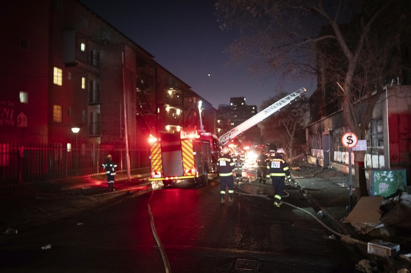 South Africa Fire Fire fighters work on the scene of a deadly blaze in downtown Johannesburg Thursday, Aug. 31, 2023. Scores of people died when a fire ripped through a multi-story building in Johannesburg, South Africa’s biggest city, emergency services said Thursday. (AP Photo)