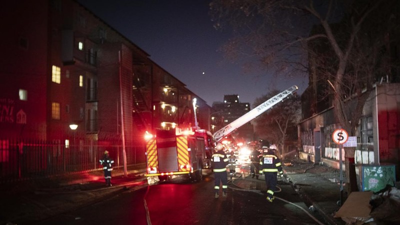Fire fighters work on the scene of a deadly blaze in downtown Johannesburg Thursday, Aug. 31, 2023. Scores of people died when a fire ripped through a multi-story building in Johannesburg, South Africa’s biggest city, emergency services said Thursday. (AP Photo)