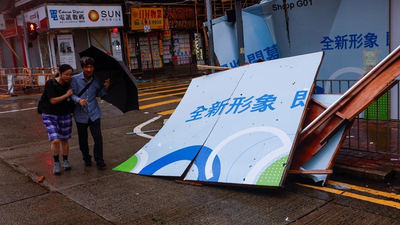 A man walks near fallen trees following Super Typhoon Saola, in Hong Kong, China September 2, 2023. REUTERS/Tyrone Siu