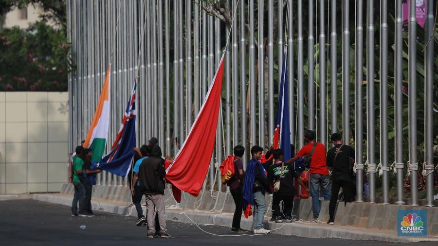 Pekerja menyelesaikan pemasangan bendera negara-negara ASEAN dan mitranya yakini China, Korea Selatan, Amerika Serikat, Jepang dan lainya di Jakarta Convention Center (JCC), Jakarta, Senin (4/9/2023). (CNBC Indonesia/Tri Susilo)