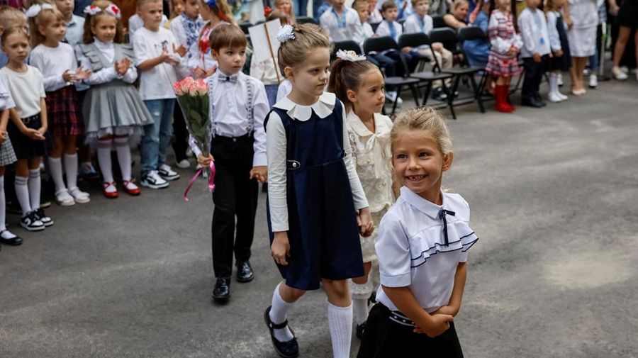Orang tua bereaksi dan mengucapkan selamat tinggal saat siswa kelas satu mereka meninggalkan upacara untuk menandai dimulainya tahun ajaran baru, di tengah serangan Rusia ke Ukraina, di Kyiv, Ukraina 1 September 2023. (REUTERS/Gleb Garanich)