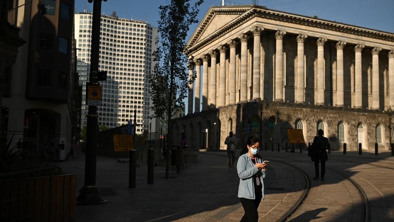 Seorang pejalan kaki melintasi jalan kosong di Birmingham, Inggris tengah pada 14 September 2020. (Photo by Oli SCARFF / AFP/File Foto)