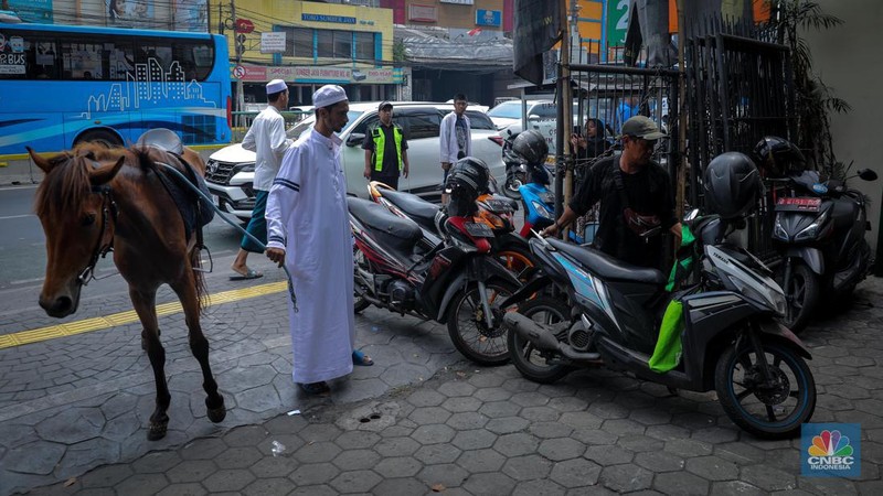 Seorang pria bernama Abdullah nampak menunggangi kuda saat melintas di Jalan Dewi Sartika, Jakarta Timur, Jumat (8/9/2023). (CNBC Indonesia/Faisal Rahman)