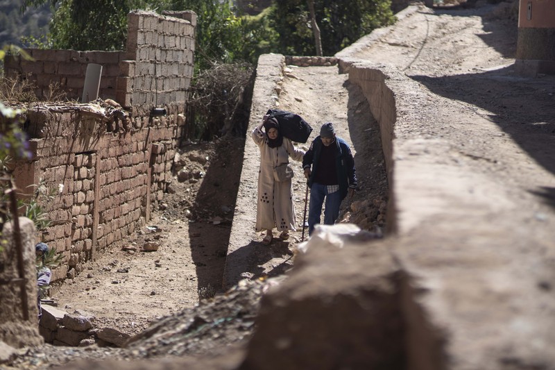 Mohammed Elhmatif and his sons, Rayan, right, and Ali, stand amidst the rubble of their home which was damaged by the earthquake, in Ijjoukak village, near Marrakech, Morocco, Saturday, Sept. 9, 2023. A rare, powerful earthquake struck Morocco, sending people racing from their beds into the streets and toppling buildings in mountainous villages and ancient cities not built to withstand such force. (AP Photo/Mosa'ab Elshamy)