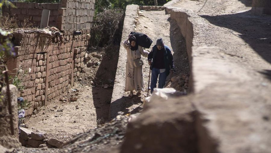 Mohammed Elhmatif and his sons, Rayan, right, and Ali, stand amidst the rubble of their home which was damaged by the earthquake, in Ijjoukak village, near Marrakech, Morocco, Saturday, Sept. 9, 2023. A rare, powerful earthquake struck Morocco, sending people racing from their beds into the streets and toppling buildings in mountainous villages and ancient cities not built to withstand such force. (AP Photo/Mosa'ab Elshamy)
