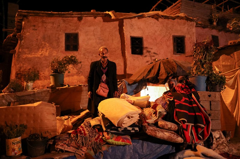 Mohammed Elhmatif and his sons, Rayan, right, and Ali, stand amidst the rubble of their home which was damaged by the earthquake, in Ijjoukak village, near Marrakech, Morocco, Saturday, Sept. 9, 2023. A rare, powerful earthquake struck Morocco, sending people racing from their beds into the streets and toppling buildings in mountainous villages and ancient cities not built to withstand such force. (AP Photo/Mosa'ab Elshamy)